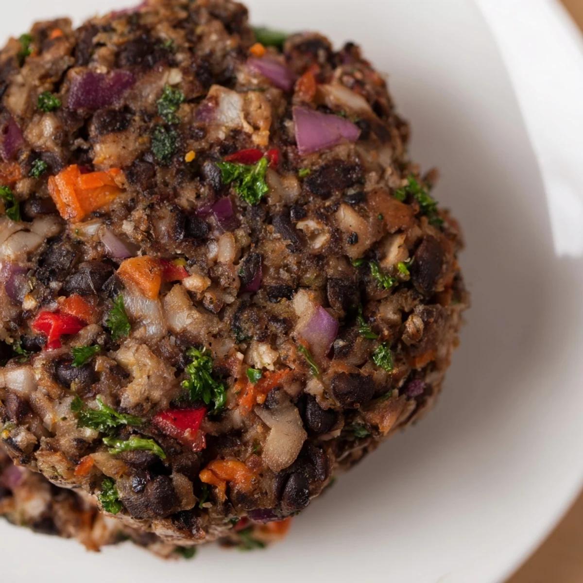Hearty vegetarian burger featuring mushrooms and black beans served with tomato slices and crisp pickles