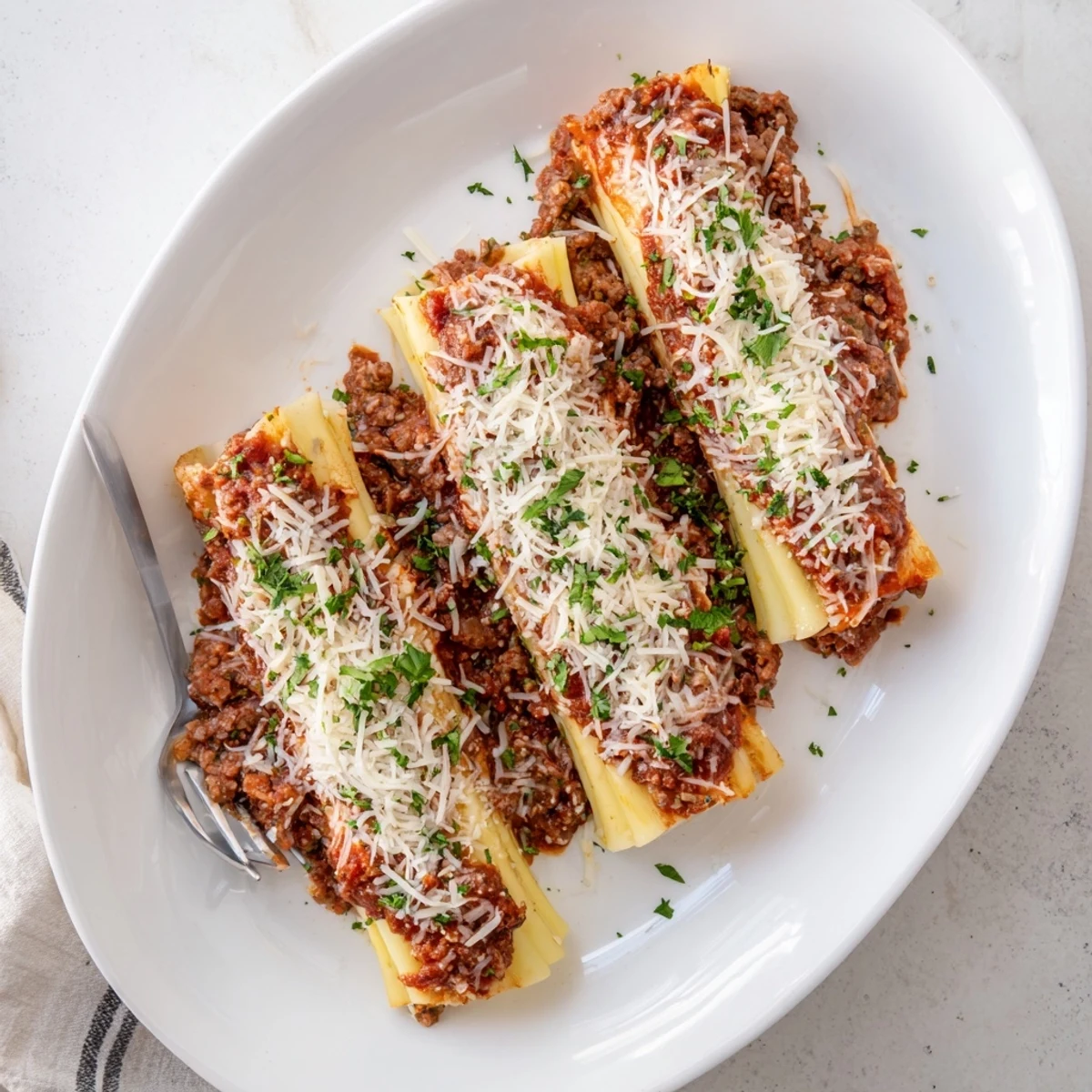 Golden baked manicotti filled with ricotta cheese and topped with savory meat sauce