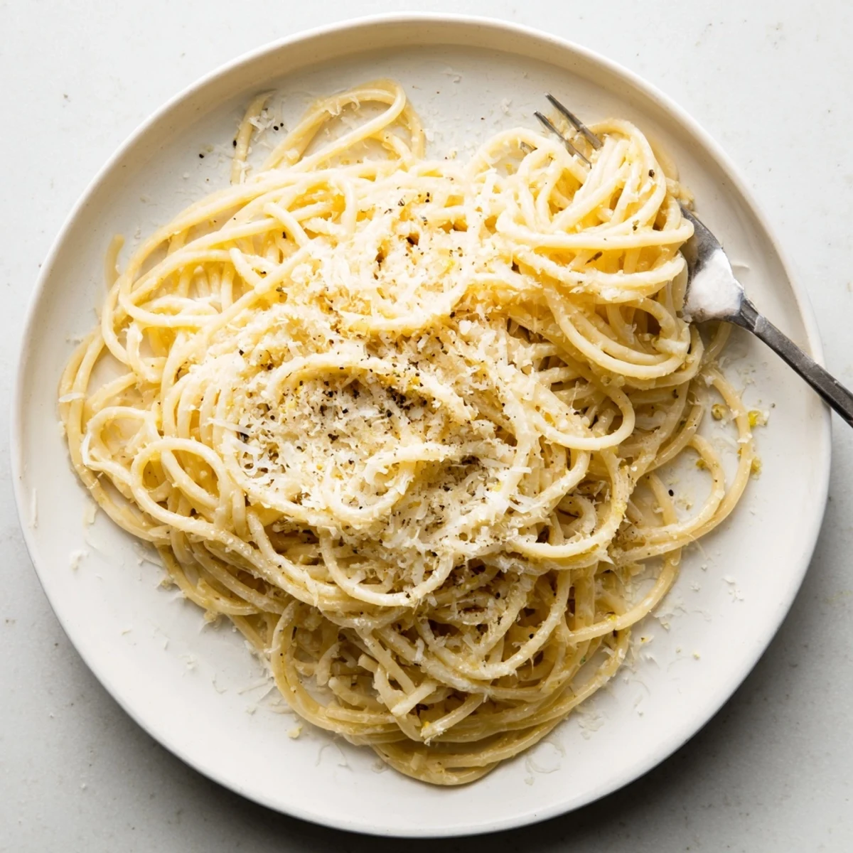 Creamy Parmesan Lemon Pasta tangled with fresh herbs and golden melted cheese