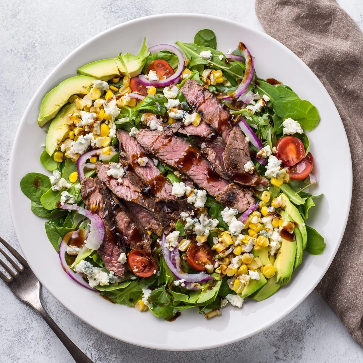 Balsamic steak gorgonzola salad drizzled with vinaigrette over fresh mixed greens