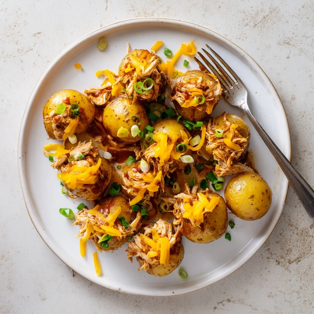 Golden roasted baby potatoes loaded with honey BBQ chicken and melted cheddar cheese