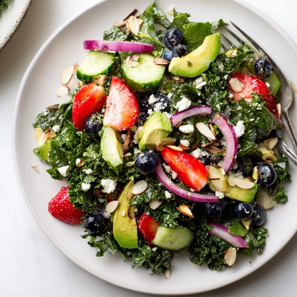 Bright summer kale salad drizzled with lemon-honey dressing in a rustic bowl