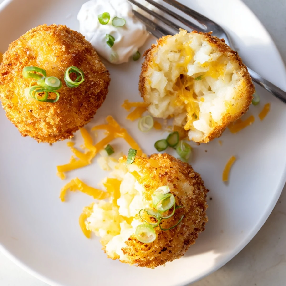 Fried Mashed Potato Balls with golden crispy exterior and gooey cheddar interior