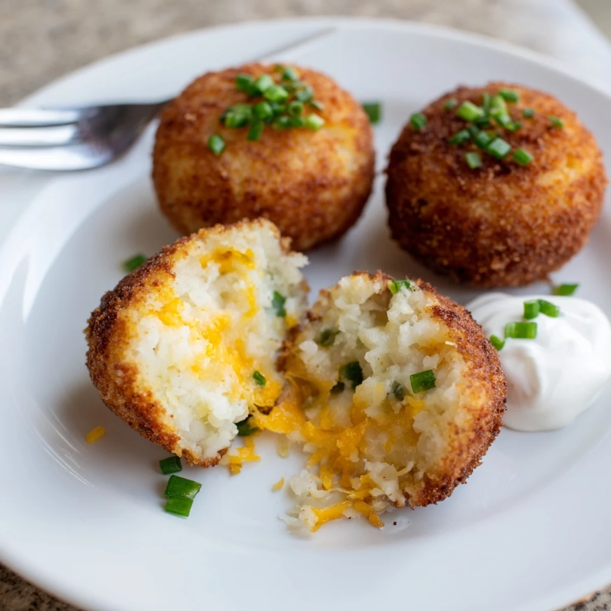 Tray of Fried Mashed Potato Balls resting on paper towels, steaming and ready