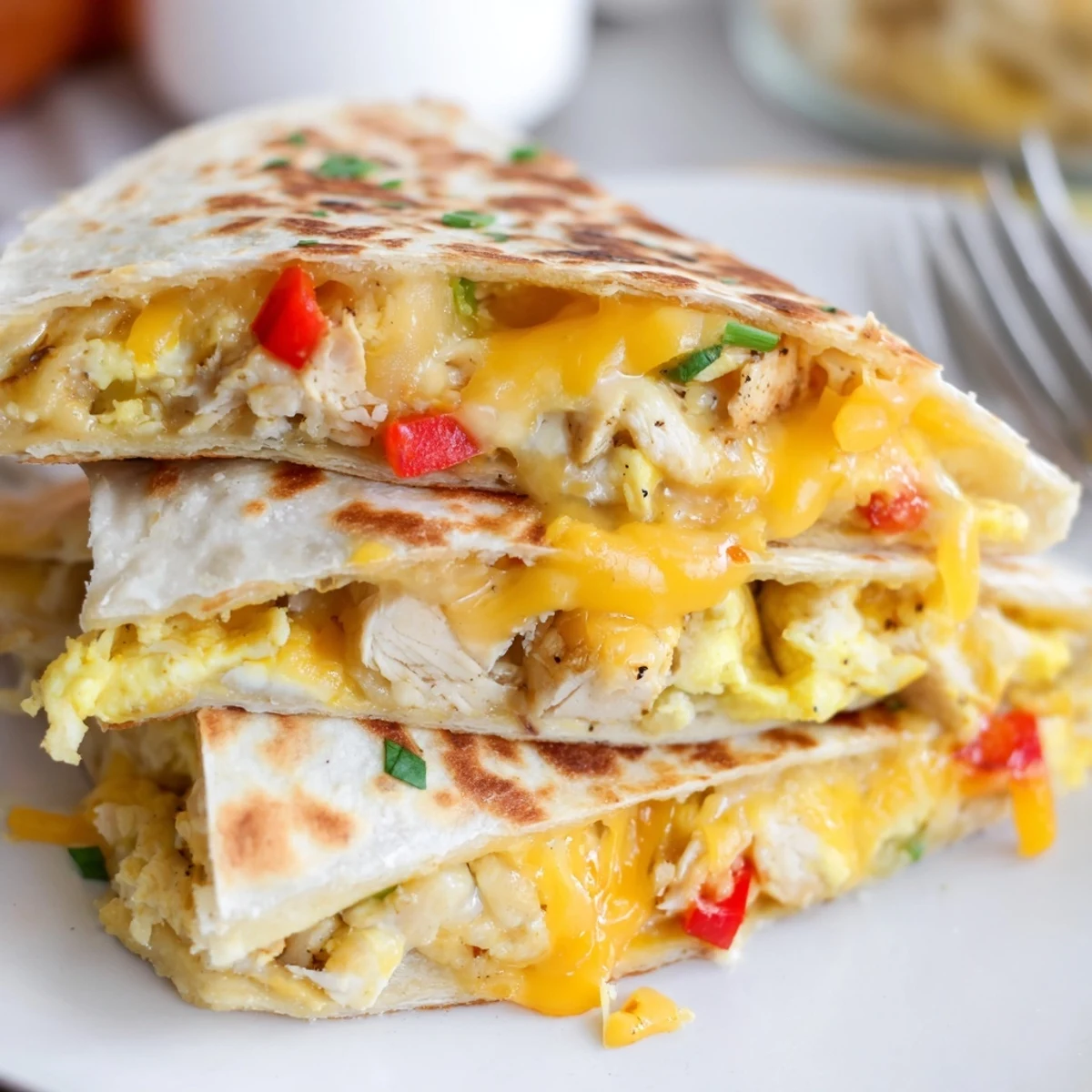 Sliced Chicken Breakfast Quesadilla served warm with scrambled eggs and fresh salsa