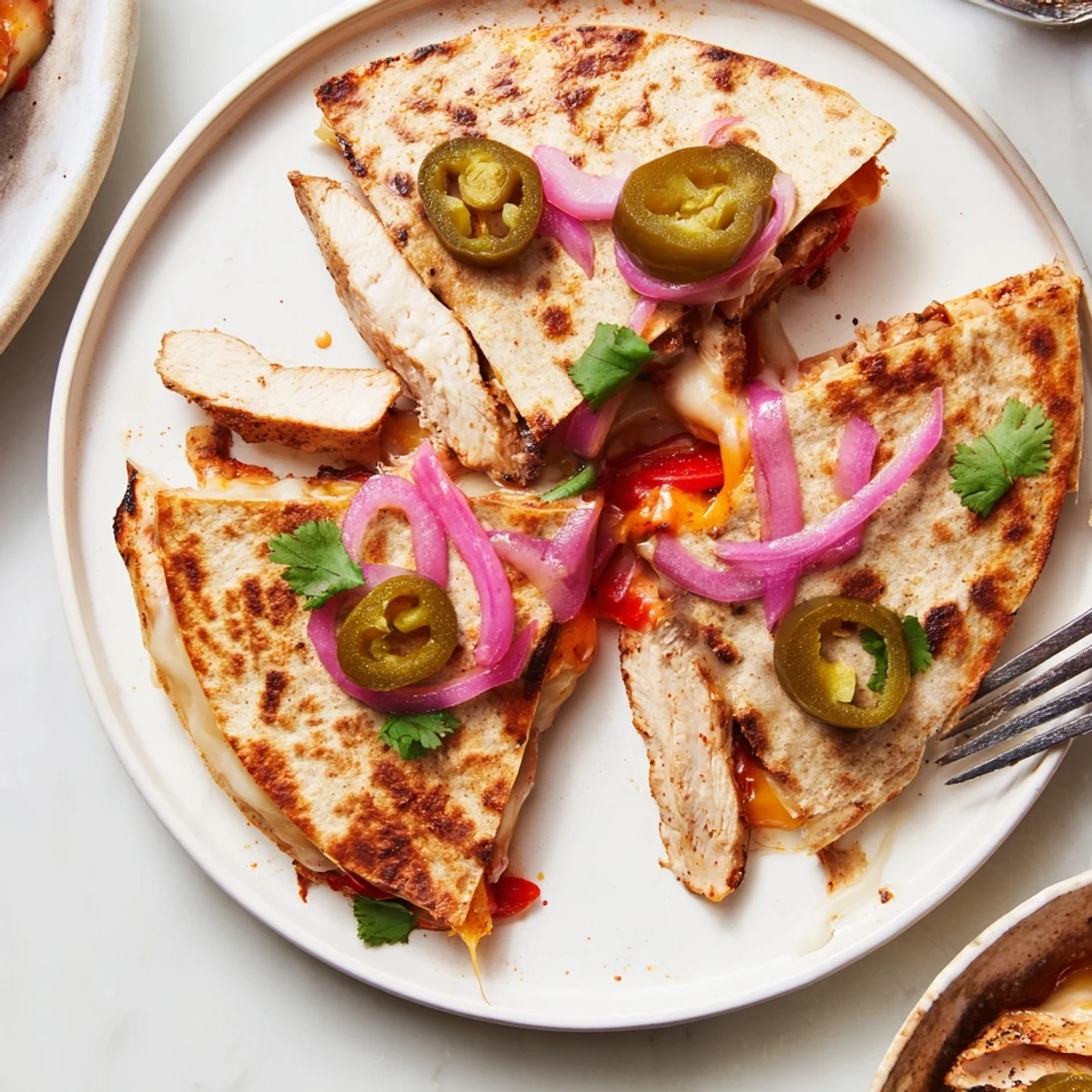 Spicy Crispy Grilled Chicken Quesadilla sliced into wedges, melty cheese oozing