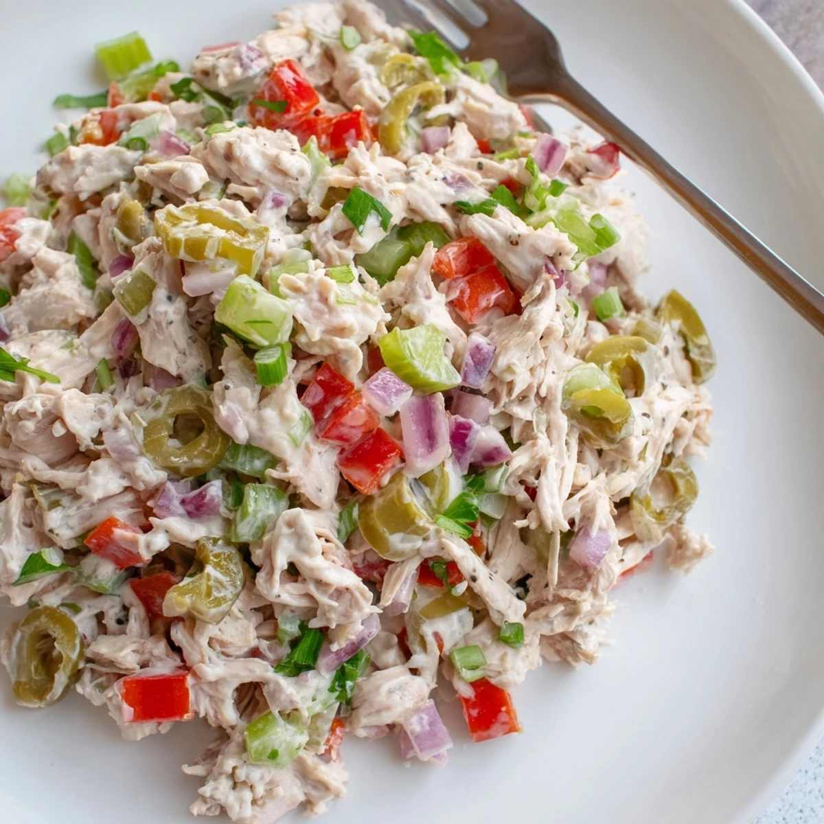 Chilled High Protein Pepperoncini Chicken Salad on mixed greens, crisp peppers.