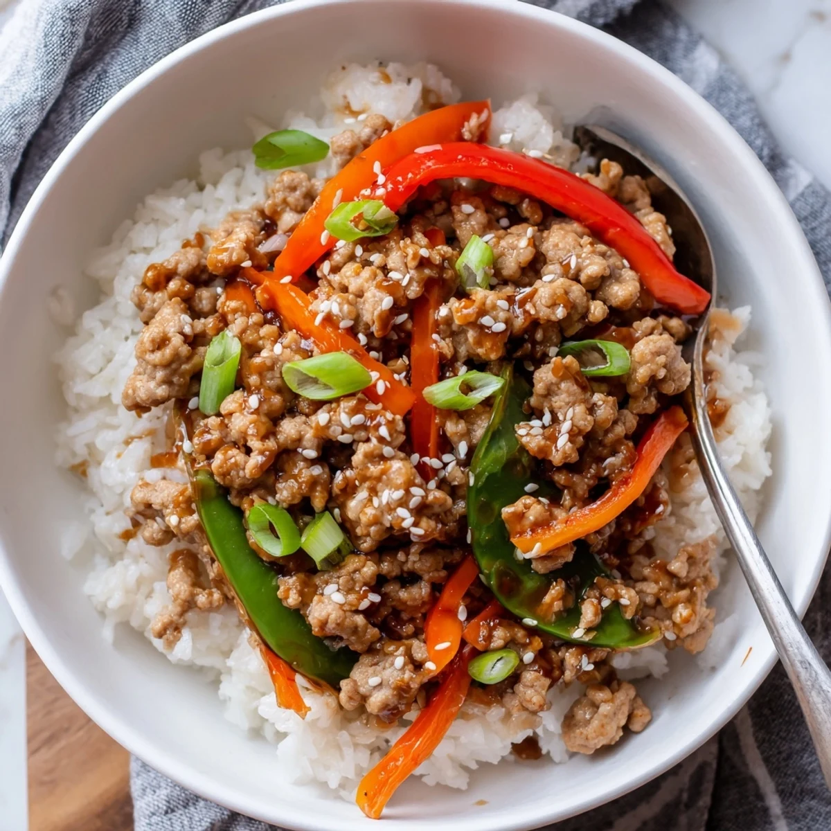 Savory glaze, sesame seeds, and sliced scallions crown Teriyaki Turkey Rice Bowls