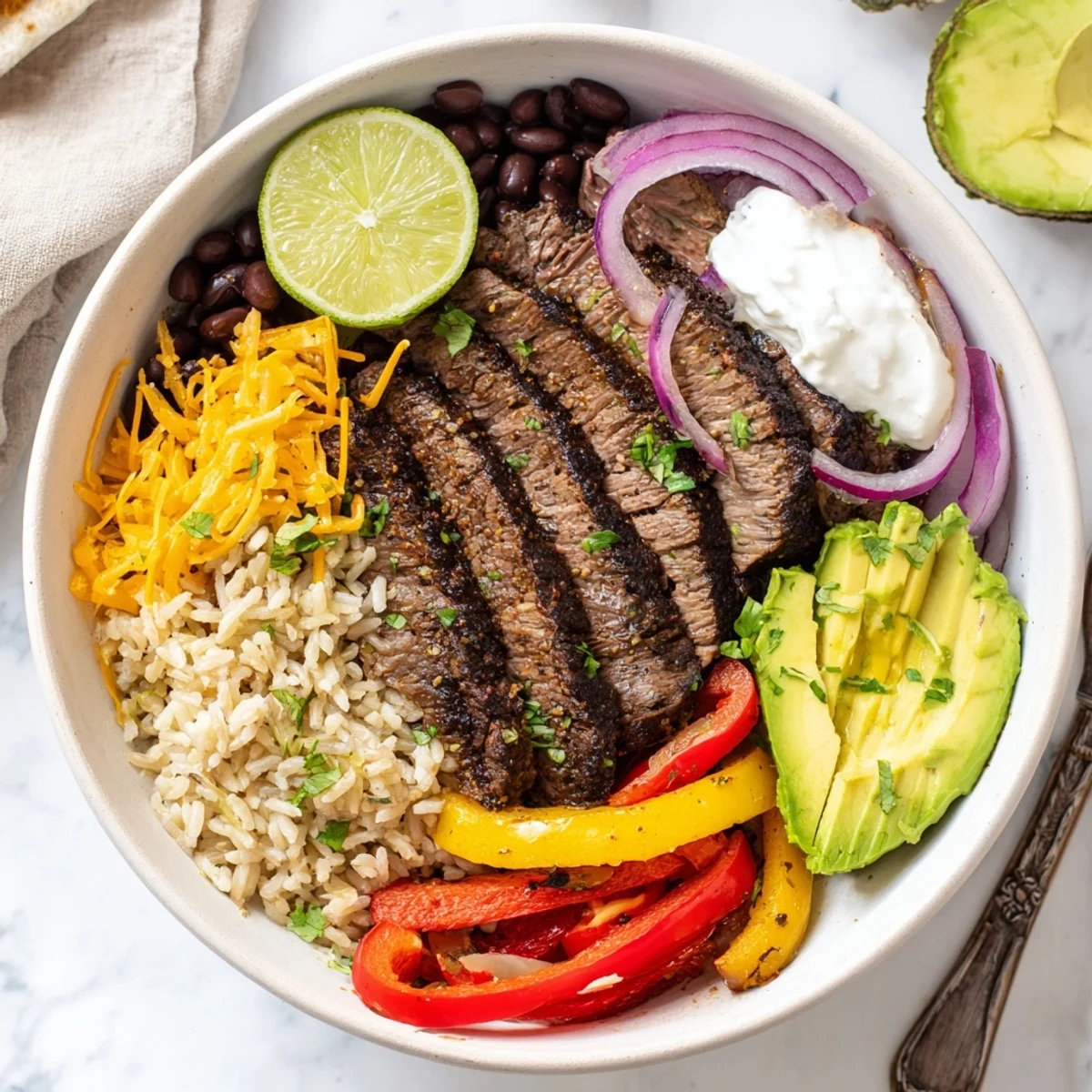 Comforting Steak Fajita Power Bowls served with creamy avocado, warm brown rice