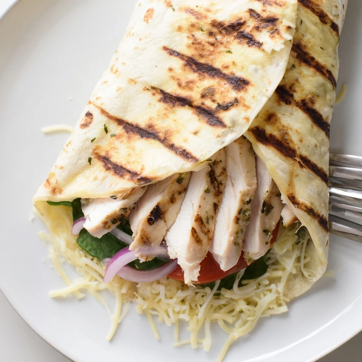 Pan-crisped Cheesy Garlic Chicken Wraps with juicy chicken and melted cheese