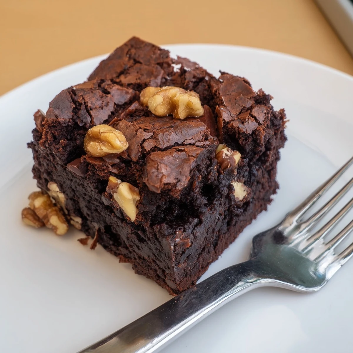 Warm ultimate brownies served with vanilla ice cream on a rustic white plate