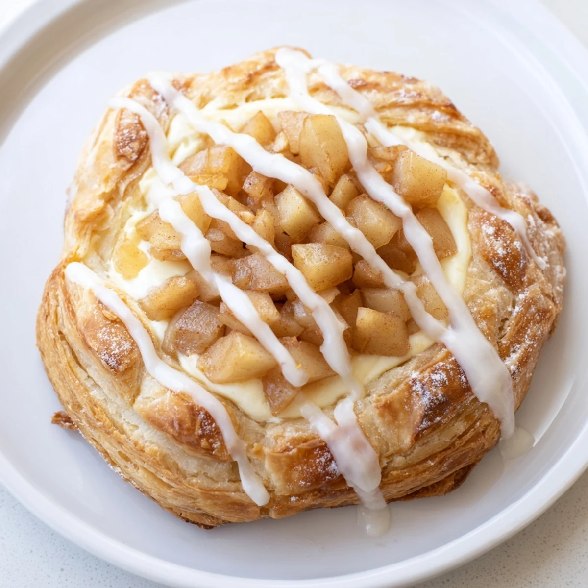 Warm Apple Cheese Danishes on a parchment lined sheet ready for brunch