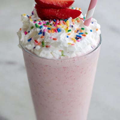 Thick strawberry milkshake blended with fresh berries and served ice-cold